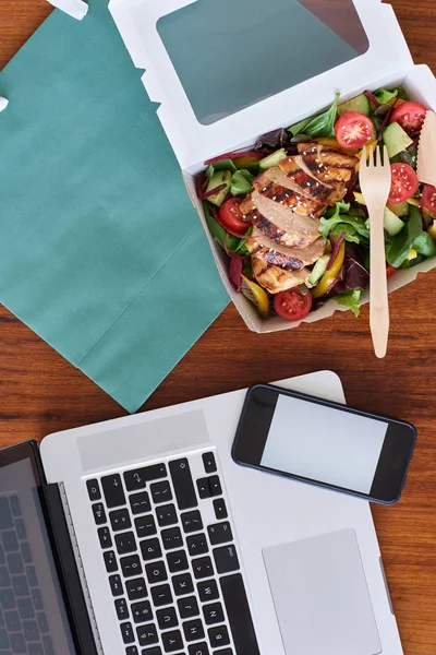 Workplace table with takeaway food — Stock Photo, Image