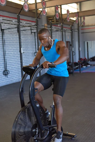 African man on exercise bike — Stock Photo, Image