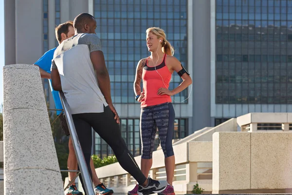 sportive people talking in street