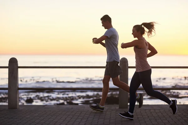 Sportive couple jogging outdoors — Stock Photo, Image