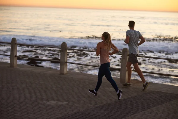 Sportive couple jogging outdoors — Stock Photo, Image