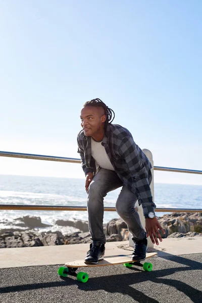 African man riding on longboard — Stock Photo, Image