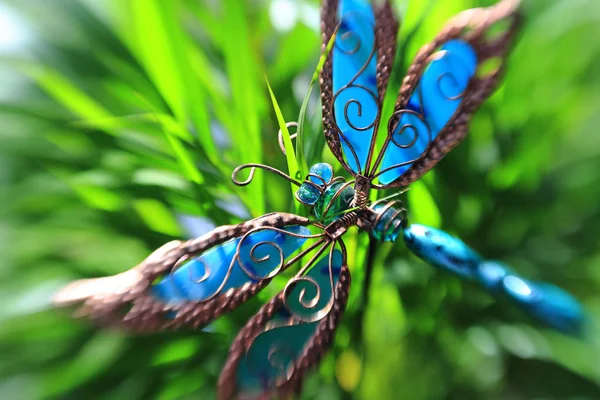 Artificial butterfly in a plant — Stock Photo, Image