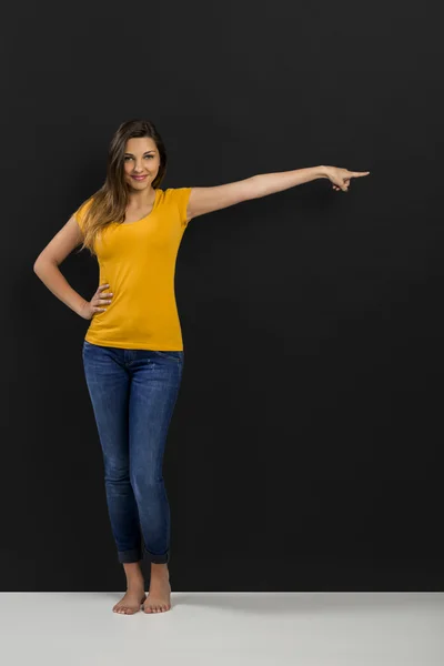 Pretty woman posing in yellow T-shirt — Stock Photo, Image