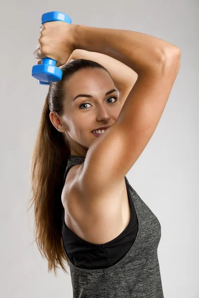 Mulher fitness com dois halteres nas mãos — Fotografia de Stock