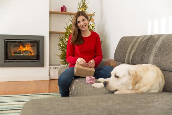 Woman sitting at home near dog — Stock Photo, Image