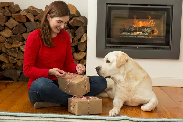 Woman sitting at home near dog — Stock Photo, Image