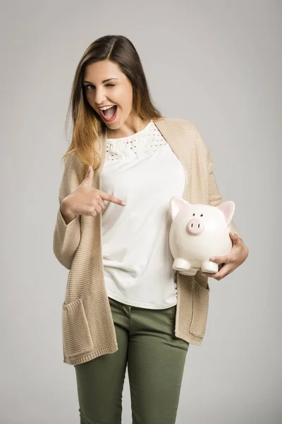 happy woman holding piggy bank