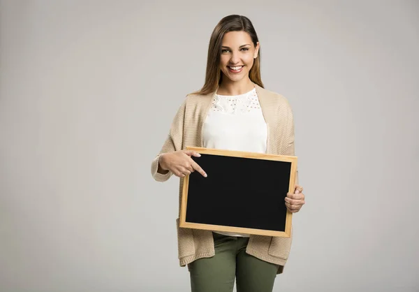 Woman holding empty chalkboard — Stock Photo, Image