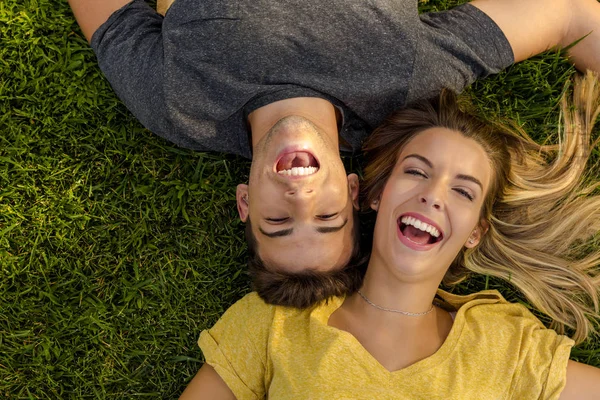 Belo casal deitado na grama — Fotografia de Stock