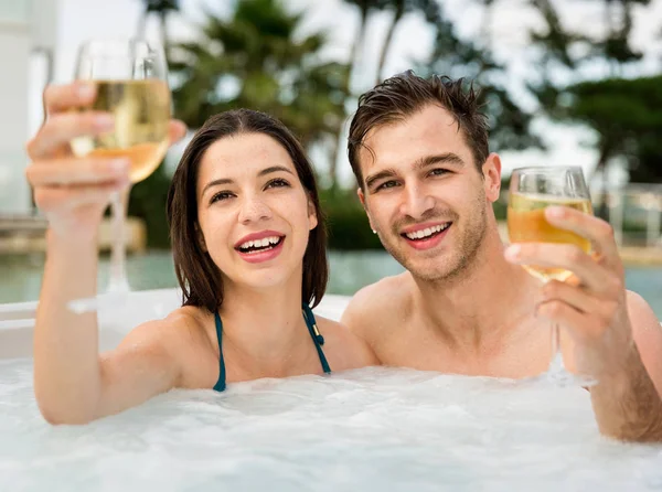 Young couple in jacuzzi — Stock Photo, Image