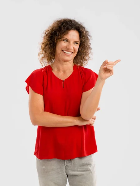 Brunette woman pointing — Stock Photo, Image