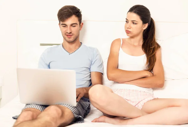 Man on bed with laptop