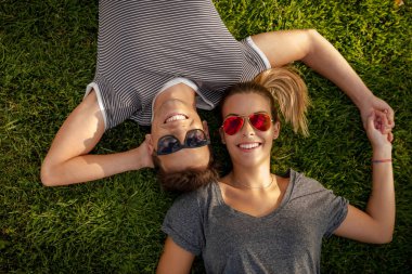 couple lying on the grass clipart