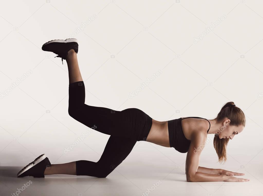 young woman doing leg exercises 
