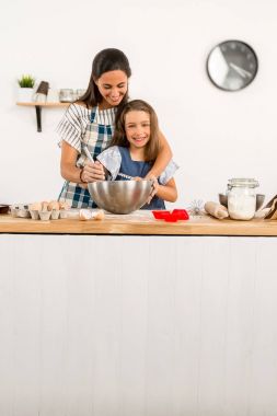  mother and daughter in the kitchen  clipart