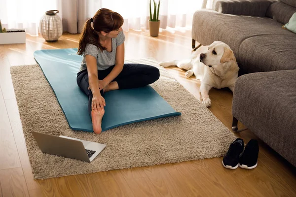 Woman doing stretches with dog — Stock Photo, Image