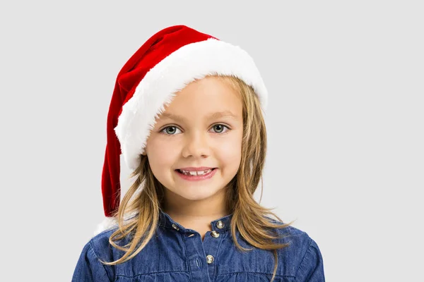 Noel Baba şapkası giyen küçük kız — Stok fotoğraf