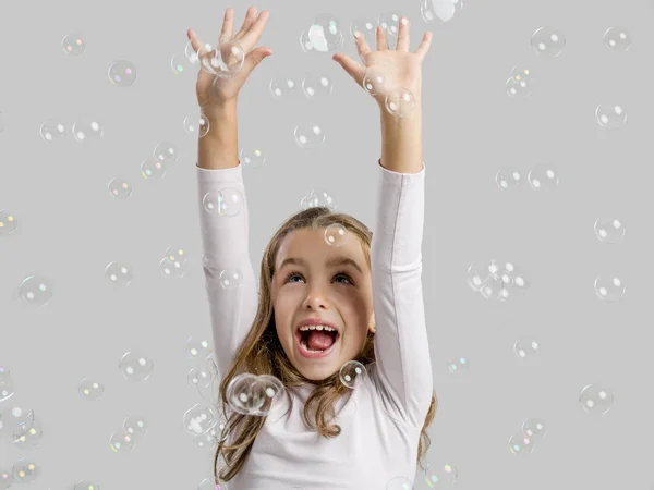 Girl playing with soap bubbles — Stock Photo, Image
