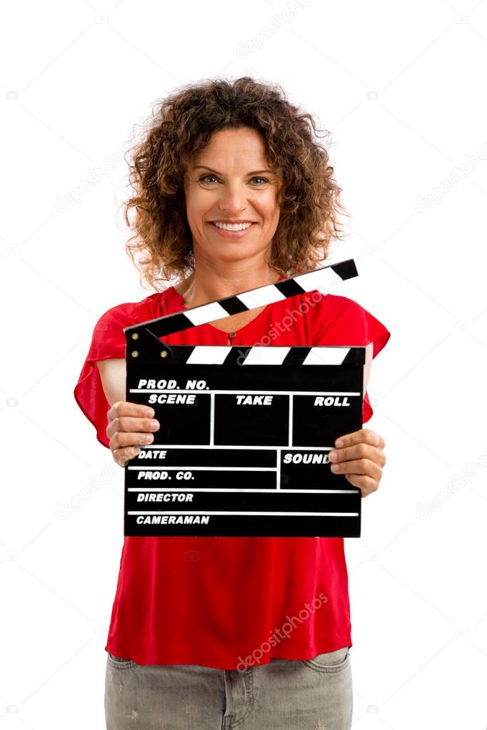 portrait of smiling middle aged brunette holding clapboard 