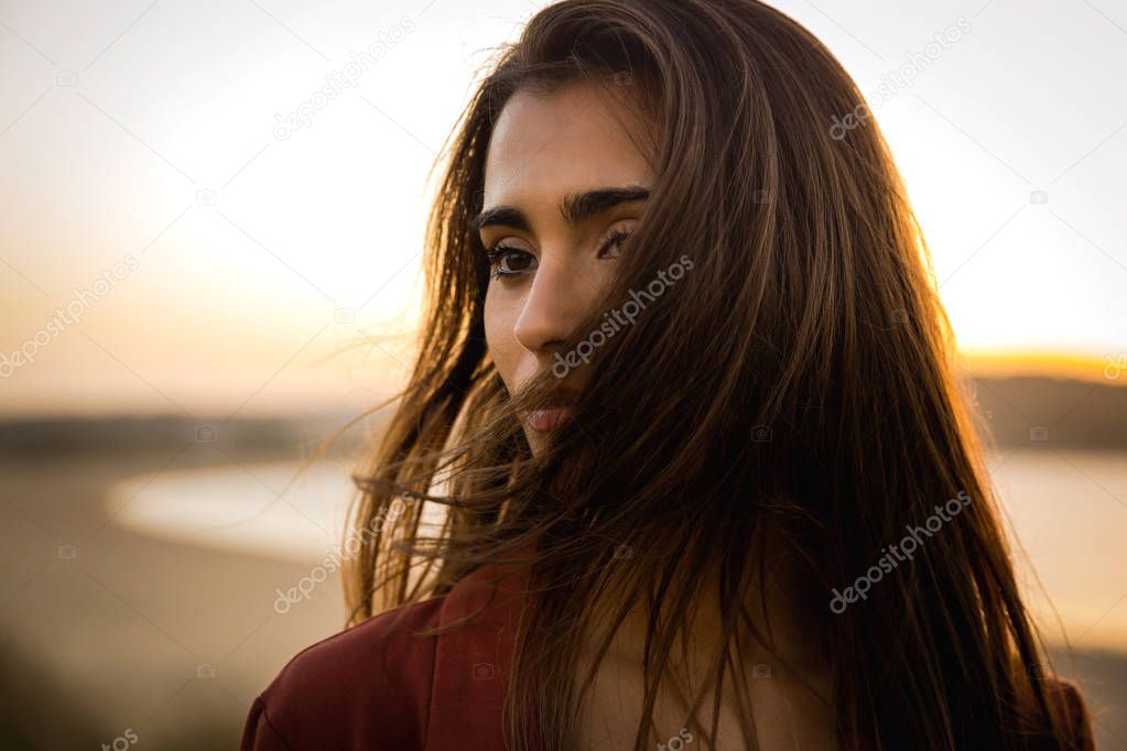 Outdoor portrait of young woman at beach