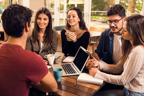 Group of friends studying together for finals