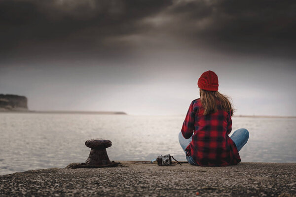 Beautiful woman enjoying her day in the lake with a mug of hot coffee