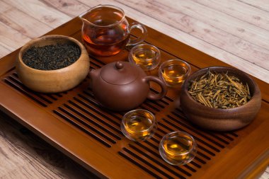 Close-up of tea set and wooden bowls on a tea table