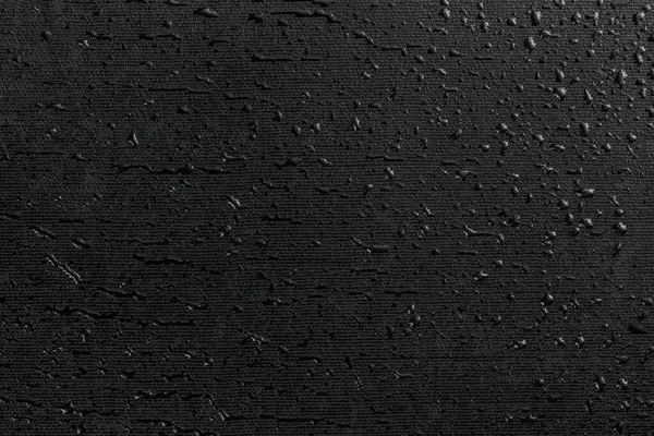 Gocce d'acqua su fondo macro in gomma piana nera — Foto Stock