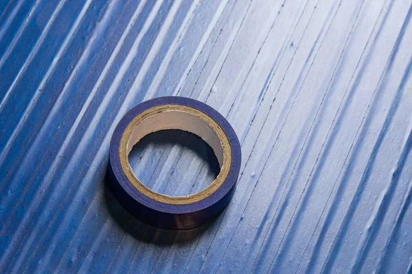 one roll of old blue pvc duct tape on ti\'s self flat background
