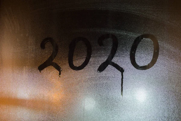 Digit 2020 written on night wet window glass close-up — Stock Photo, Image