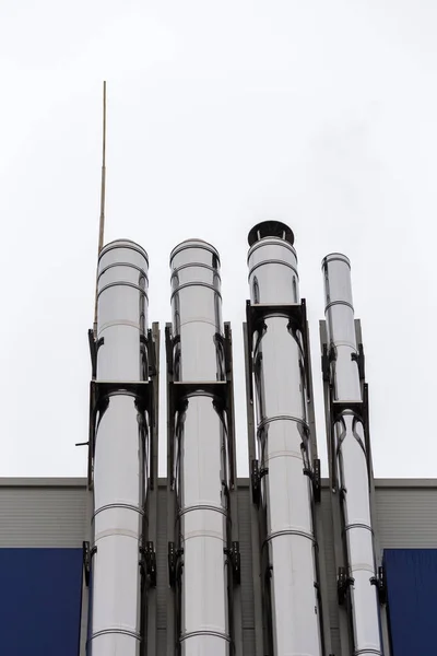 Chrome ventilation pipes on the outside wall of the white and blue Industrial building — Stock Photo, Image