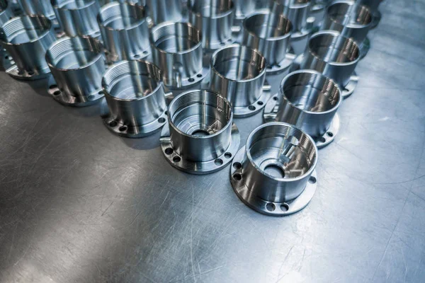 A batch of shiny metal cnc made aerospace parts production - close-up with selective focus for industrial background — 스톡 사진