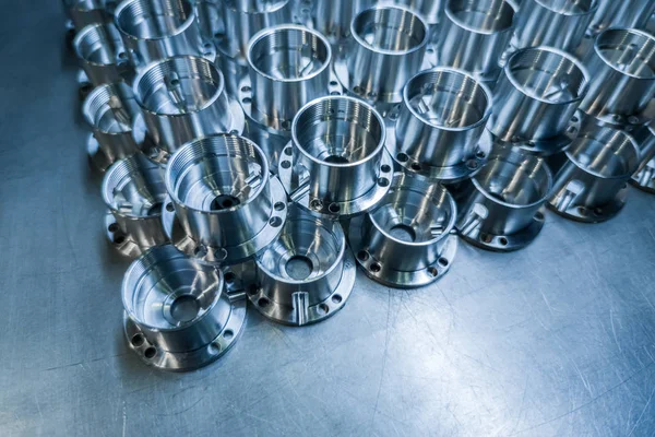 Shiny metal aerospace parts after cnc machining on steel surface with selective focus, industrial background — 스톡 사진