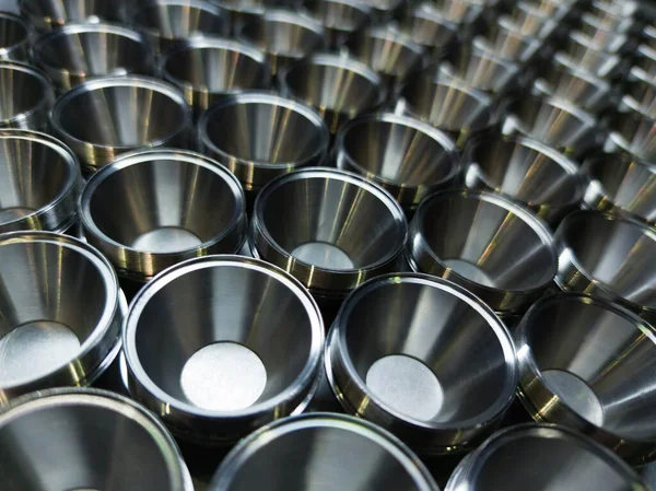 Shiny steel parts background. Regular industrial metal production pattern with selective focus. — 스톡 사진