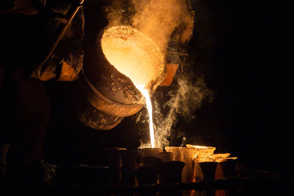 Industrial lost wax casting. The process of pouring for filling out ceramic shells with molten steel.