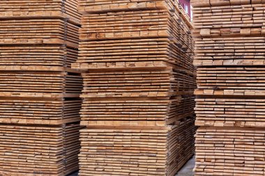 large stacks of wooden planks full frame background with perspective