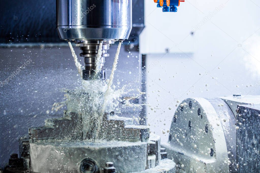a process of industrial wet milling in 5-axis cnc machine with coolant flow under pressure and freezed splashes