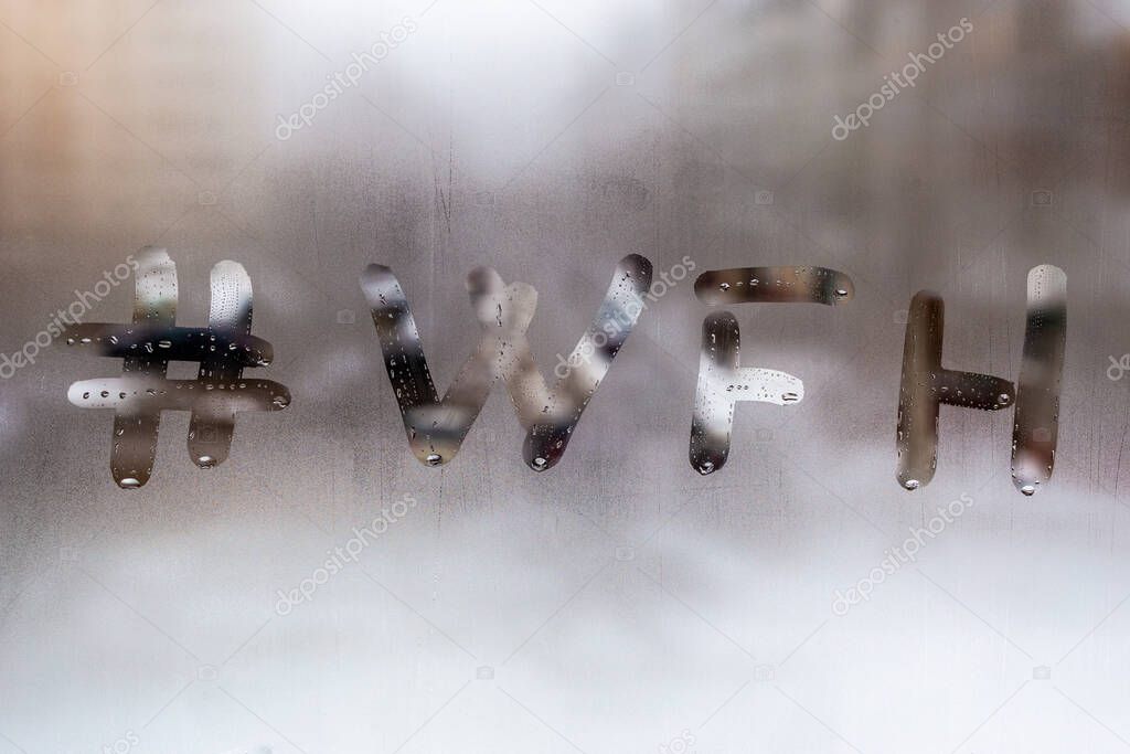 hashtag word wfh - work from home handritten on wet window glass at cloudy weather