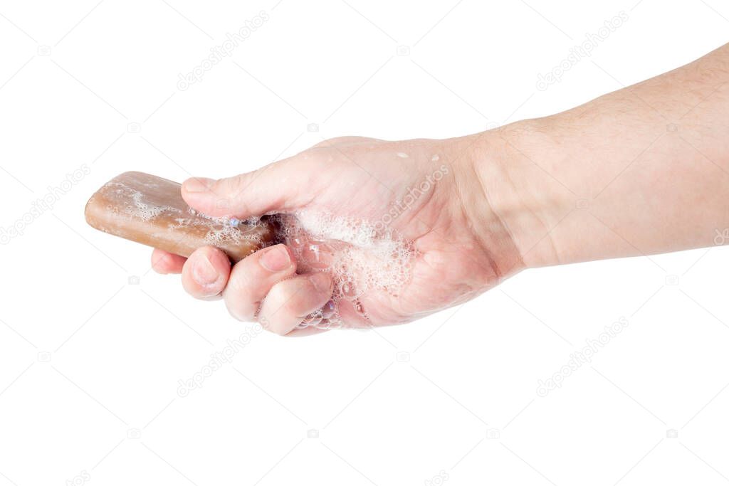 bare caucasian hand giving a wet bar of tar soap isolated on white background