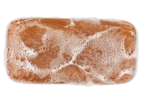 Wet piece of brown tar soap isolated on white background in flat lay directly above perspective — Stock Photo, Image