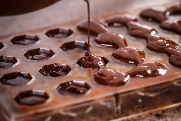 Putting chocolate in mold — Stock Photo, Image