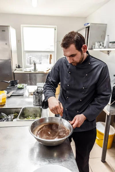 Chef batiendo chocolate, huevos y mantequilla — Foto de Stock