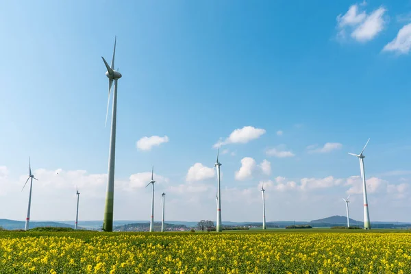 Wind farm in a blooming rapeseed field — Stock Photo, Image