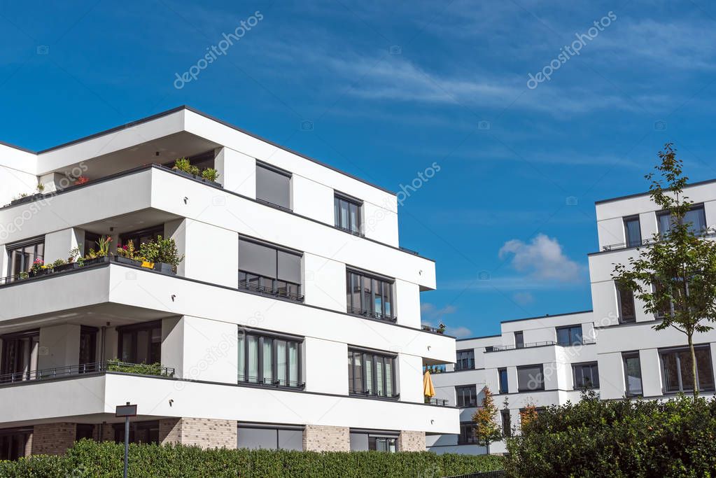 New white townhouses in front of a blue sky seen in Berlin, Germany