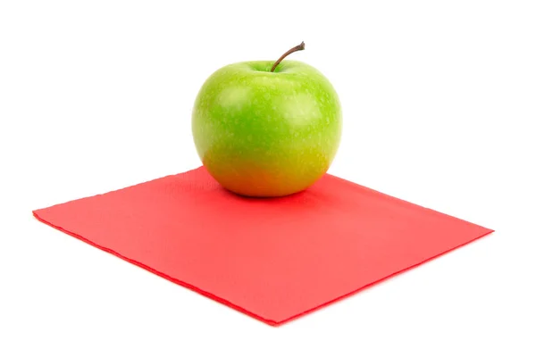 Green apple on red napkin — Stock Photo, Image