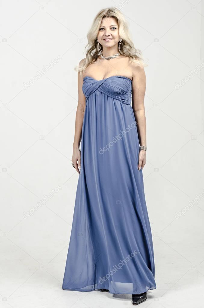 Beautiful blonde woman in a blue cocktail dress