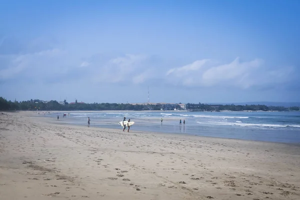 Sufer paar dragende surboards kuta strand bali Rechtenvrije Stockfoto's