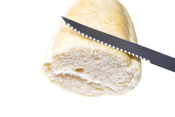 Piece of french bread with a knife on white — Stock Photo, Image