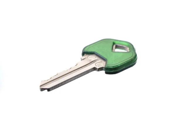 Макро знімок ключа з зеленою кришкою над білим — стокове фото